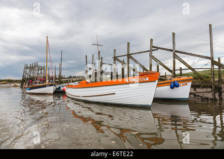 Boats moored at Morston for trips to see seals at Blakeney Point, Norfolk, UK Stock Photo