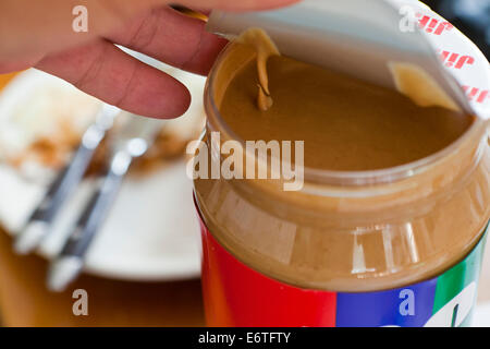 man opening new peanut butter jar - USA Stock Photo