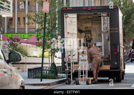 UPS delivery man unloading packages from truck - Washington, DC USA Stock Photo