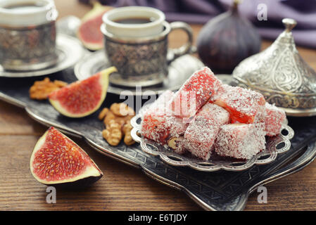 Cup of coffee with turkish delight  and metal oriental tray on wooden background Stock Photo