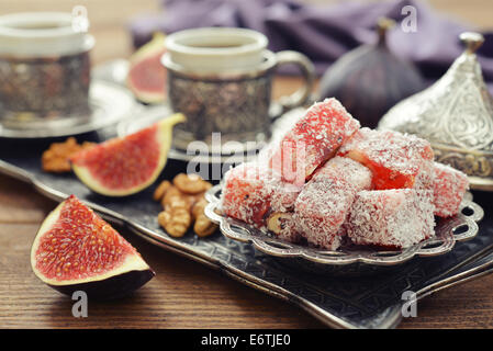 Cup of coffee with turkish delight  and metal oriental tray on wooden background Stock Photo