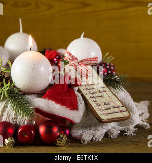 First advent with one red burning candle on the wreath. Stock Photo