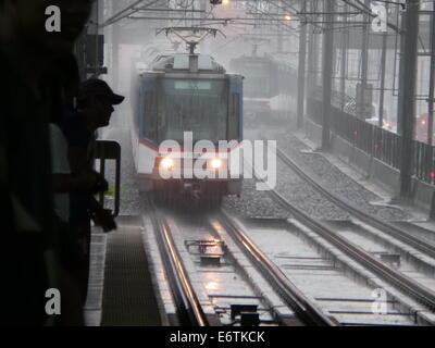 Makati, Philippines. 31 August, 2014. MRT train running 40 kph during a rainy afternoon. Metro Manila is experiencing heavy rains as if brace rainy season. Credit:  Sherbien Dacalanio / Alamy Live News Stock Photo