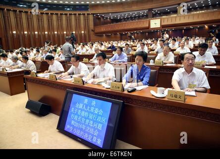 Beijing, China. 31st Aug, 2014. Members vote during the closing meeting of the 10th session of the 12th National People's Congress (NPC) Standing Committee in Beijing, capital of China, Aug. 31, 2014. Credit:  Liu Weibing/Xinhua/Alamy Live News Stock Photo
