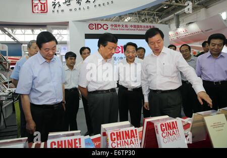 Beijing, China. 31st Aug, 2014. Liu Yunshan (2nd L front), a Standing Committee member of the Communist Party of China Central Committee Political Bureau, learns about the book publishing on introducing China's development with foreign language while visiting the Beijing International Book Fair in Beijing, China, Aug. 31, 2014. Credit:  Liu Weibing/Xinhua/Alamy Live News Stock Photo
