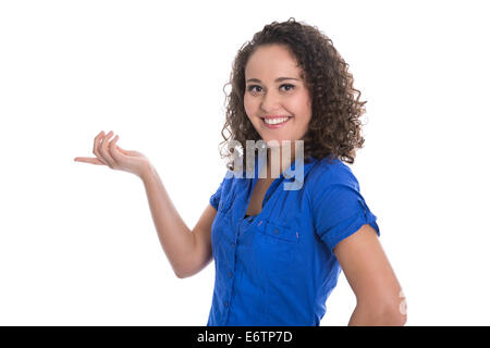 Isolated smiling girl making promotion showing something with her finger. Stock Photo