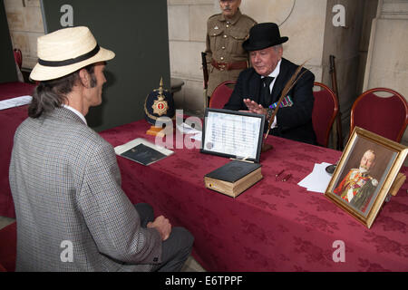 Army Recruiting soldiers, affirming on the bible at Liverpool, Merseyside, UK 31st August, 2014. Prince Edward at Liverpool Pals commemoration and the re-enactment of the Liverpool Pals signing up to answer Lord Derby's call for recruits 100 years to the day it happened. Liverpool's success prompted other towns to form units, with civic pride and community spirit driving a competition to raise the highest numbers. Stock Photo