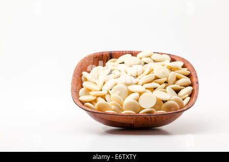 on white background, there is a bowl with  white chocolate Stock Photo