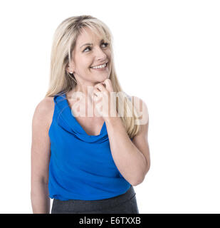 Beautiful isolated mature woman in blue summer shirt - happy and looking sideways. Stock Photo
