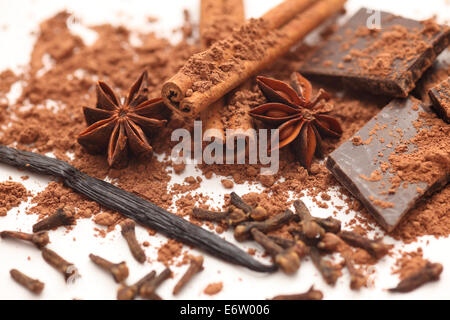 Chocolate, vanilla, cloves, star anise, and cinnamon sticks. Closeup. Stock Photo