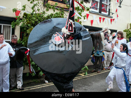 The Red Oss dancing in the streets of Padstow, Cornwall, UK  on Obby Oss day Stock Photo