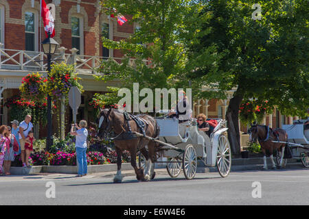Horse drawn carriage in Village of Niagara on the Lake on the Niagara River in Ontario Canada Stock Photo