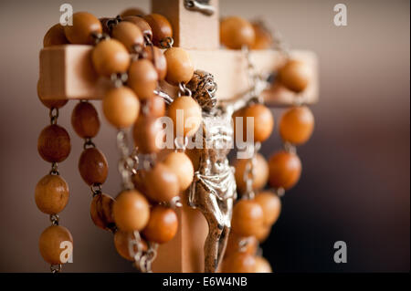 Wood rosary and Jesus figurine Stock Photo