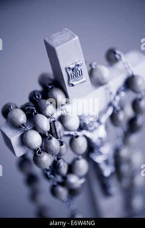 Blue toned rosary made of wooden beads Stock Photo