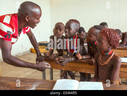 Hamer Tribe Kids With The Teacher In A School, Turmi, Omo Valley, Ethiopia Stock Photo