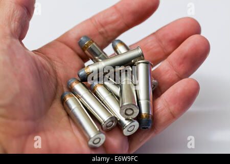 Man holding handful of Winchester 357 magnum hollow point bullets (ammunition) - USA Stock Photo