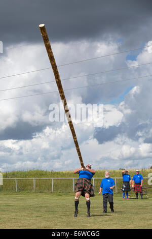 Calgary, Alberta, Canada. 30th Aug, 2014. Competitor tosses a caber during the Calgary Highland Games, Calgary, Alberta, Canada on Saturday Aug. 30, 2014. The Calgary games are a longstanding tradition, going into their second century this year. Credit:  Rosanne Tackaberry/Alamy Live News Stock Photo