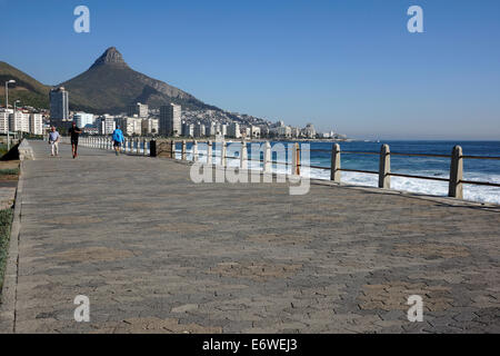 People walking and jogging along the Sea Point promenade near Cape Town. Stock Photo