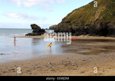 Lifeguards carrying kayak on Llangrannog Beach Ceredigion Wales Cymru UK GB Stock Photo