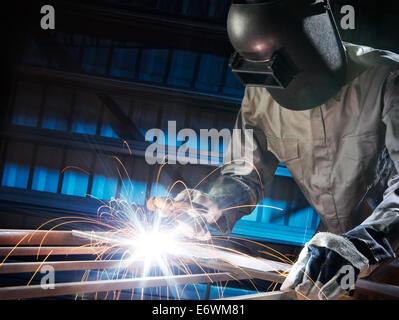 man welding in workshop with safety precaution Stock Photo