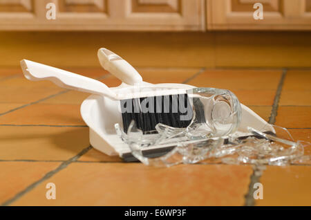 remnants pile of broken glass on floor after accident and glass slipped out of wet hands knocked over Stock Photo