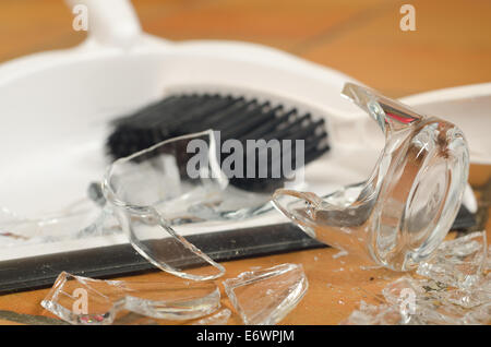 remnants pile of broken glass on floor after accident and glass slipped out of wet hands knocked over Stock Photo