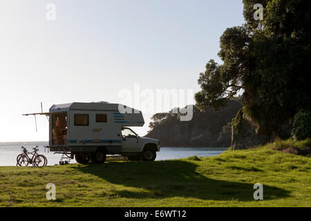 4WD camper van parked on the beach, small camping ground, East Cape, North Island, New Zealand Stock Photo