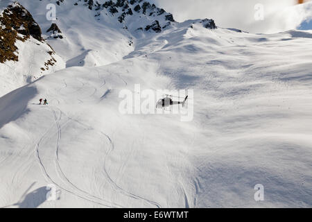 Helicopter landing with winter sportsmen, Skiers and snowboarders, Queenstown, South Island, New Zealand Stock Photo