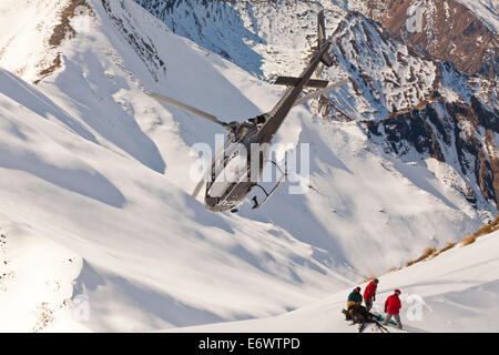 Helicopter landing with winter sportsmen, Skiers and snowboarders, South Island, New Zealand Stock Photo