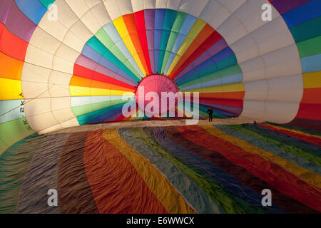 Brightly coloured hot air balloon from the inside, about to be filled with air before take-off, Sport Stock Photo