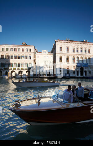 View of water taxis on the Grand Canal and towards palace Palazzo Grassi and Palazzina Grassi Hotel, Design Philippe Starck, Ses Stock Photo