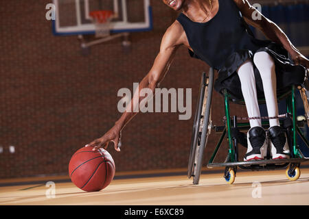 Man with Spinal Meningitis in wheelchair playing basketball Stock Photo