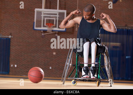 Man with Spinal Meningitis in wheelchair playing basketball Stock Photo