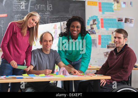 Engineering students in ideation lab one man with spinal cord injury and other one with Aspergers Stock Photo