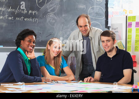 Engineering instructor and project group in prototyping and fabrication lab one man with spinal cord injury and other one with Aspergers Stock Photo