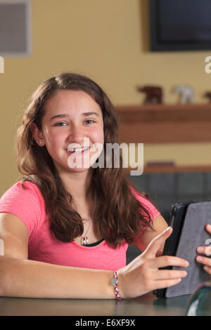 Teen girl using her digital tablet Stock Photo