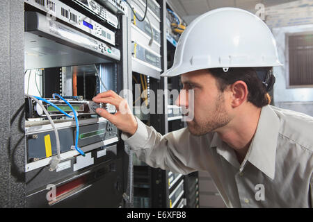 Network engineer working in a server room Stock Photo