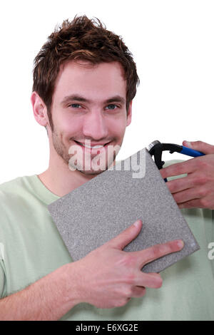 Man with a tile cutter Stock Photo