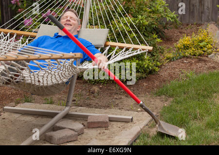 Man with Cerebral Palsy and dyslexia relaxing in his hammock Stock Photo