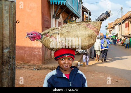 Madagascan boy carrying a turkey on his head, Betsileo tribe, Ambalavao, Fianarantsoa Region, Madagascar, Africa Stock Photo