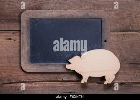 Menu board with pink pig on wooden background for New Year, sylvester, birthday or for a butcher - to say good luck Stock Photo