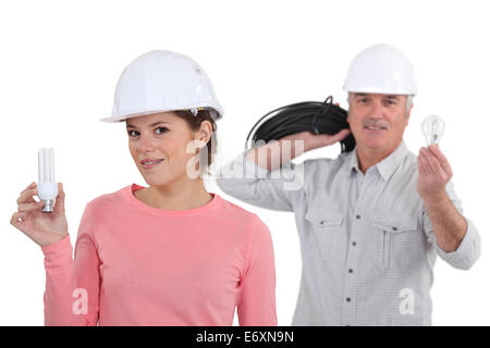 craftsman and craftswoman holding a bulb Stock Photo