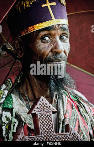 Priest with umbrella and cross in Lalibela, Ethiopia, Africa Stock Photo