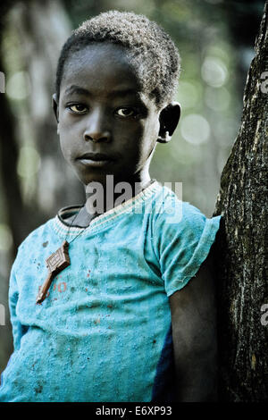 Young woman from the Konzo tribe leaning against a tree, South Ethiopia, Africa Stock Photo