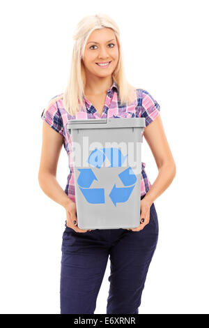 Blond woman holding a recycle bin isolated on white background Stock Photo