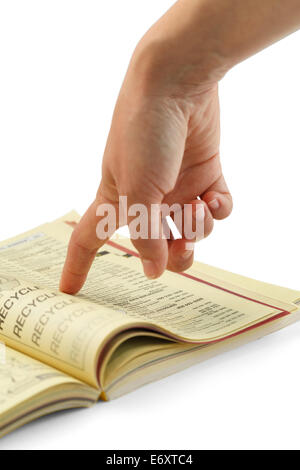Finger Pointing Searching Yellow Phone Book. Stock Photo