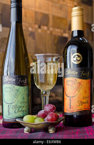 Glass of white Canadian wine with two bottles of Oliver Twist wine from the Okanagan area of British Columbia. Stock Photo