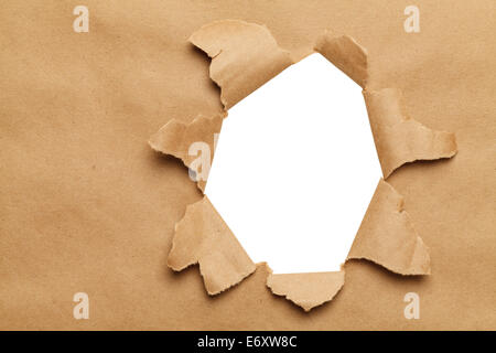 Large Hole in Brown Paper With White Background. Stock Photo