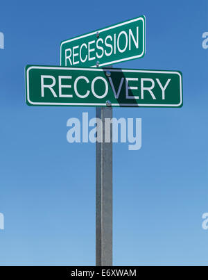 Two Green Street Signs Recession and Recovery on Metal Pole with Blue Sky Background. Stock Photo