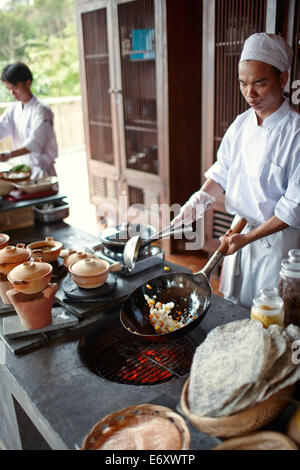 Chefs cooking in open kitchen of a hotel, Dat Doc Beach, Con Dao Island, Con Dao National Park, Ba Ria-Vung Tau Province, Vietna Stock Photo